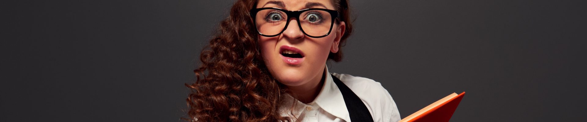 funny woman with book can't understand her lessons. picture over dark background